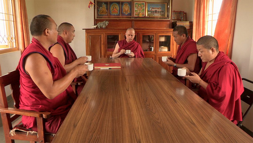 At the beginning of the film, he sips tea (or hot water?) and he is the only monk to have a soucoupe under his cup!