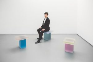 Wonmin Park sitting on his new "Haze" stools