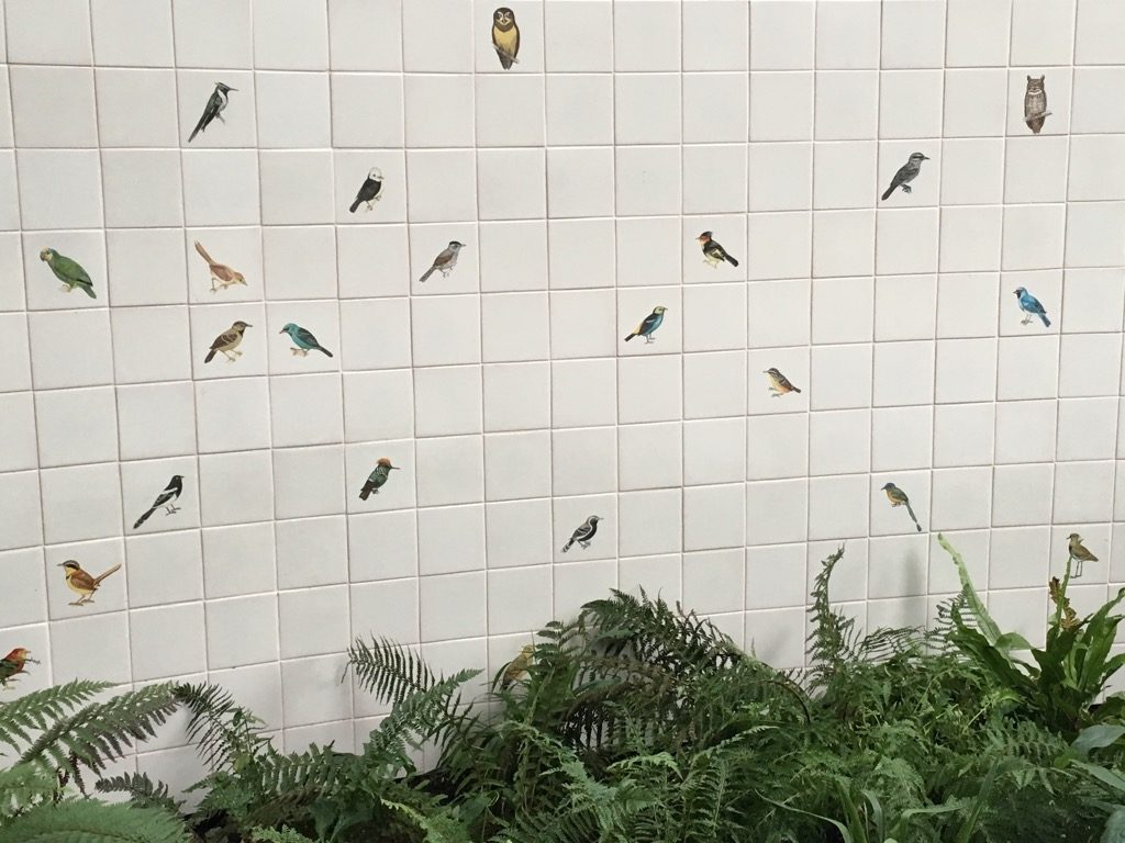 Brazilian artist Adriana Varejano created a wall with bird painted ceramics