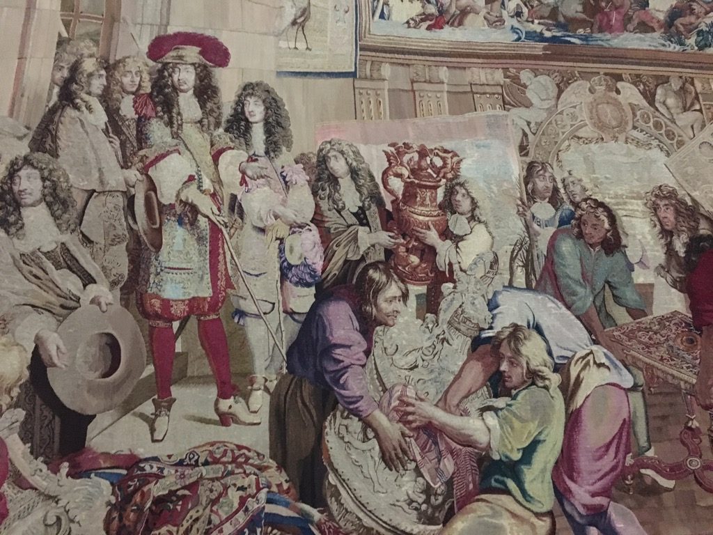 Gobelins Tapestry of Lousi XIV visiting his Manufacture: one can see Le Brun on the lower right of the King (detail)